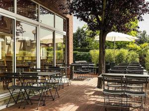 a group of tables and chairs in front of a building at ibis Massy in Massy