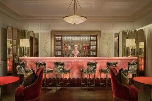 a bar with red chairs and a pink bench at Maxwell Reserve Singapore, Autograph Collection in Singapore