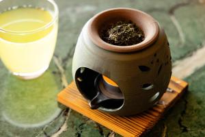 a pot with a plant in it next to a glass of milk at Inatori Tokai Hotel Yuen in Higashiizu +125 photos