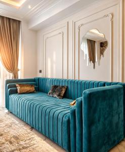 a blue couch sitting in a living room at FIRST RESIDENCe in Mamaia +12 photos