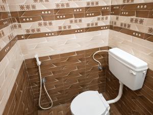 a bathroom with a white toilet in a room at Hotel Sabareesh Kanyakumari in Golden Rock +16 photos