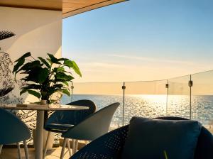 a restaurant with a table and chairs and the ocean at FIRST RESIDENCe in Mamaia