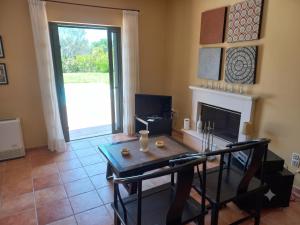 a living room with a table and a fireplace at Private Pool Villas in Svoronata