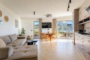 a living room with a couch and a table at RIRIKA Beach Living, New Seaside Apartments in Plakias in Plakias