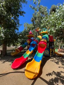a row of colorful rainbows on a playground at Le Camping de la Plage in Aregno