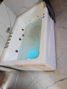 a bath tub with a glass shower in a bathroom at Hotel Akshara Inn in Nasīrābād