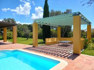 a pergola over a swimming pool with a table and a picnic table at Private Pool Villas in Svoronata +8 photos