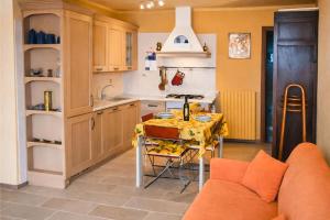 a kitchen with a table with a yellow table cloth at Il Pergolato in Cannero Riviera