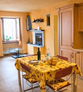 a kitchen with a table with a yellow table cloth at Il Pergolato in Cannero Riviera