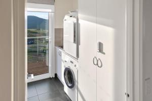 a washer and dryer in a room with a window at Spotted Gum -Merrijig in Merrijig