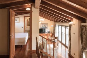 a bedroom with a bed and a staircase in a room at Phi Hotel Dei Medaglioni in Correggio +116 photos