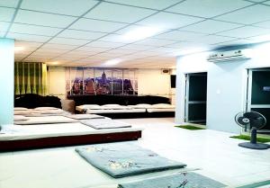 a room with several beds in it with a room with at KHÁCH SẠN THU NGUYỄN - ngay BẾN NINH KIỀU, CHỢ ĐÊM in Can Tho