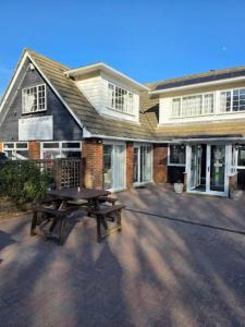 a picnic table in front of a house at Coastguard cafe room 2 in Hastings