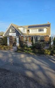 a large house with a driveway in front of it at Coastguard cafe room 2 in Hastings