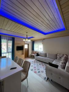 a living room with a blue led ceiling at Nirvana Suite Hotel in Uzungöl