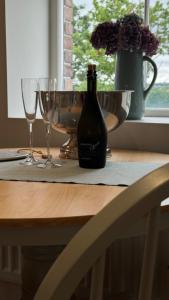 a bottle of wine sitting on a table with two glasses at The Loft in Cookstown Junction +21 photos