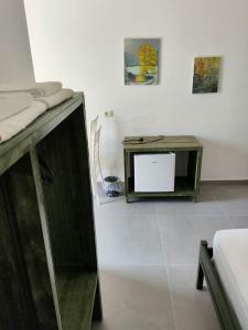 a living room with a table and a tv at John's Guesthouse in Ksamil