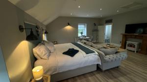 a bedroom with a large bed and a fireplace at The Loft in Cookstown Junction