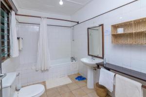 a white bathroom with a sink and a toilet at Driftwood Beach Malindi Palace in Malindi +21 photos