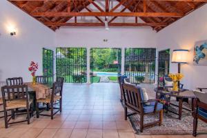 a living room with a table and chairs and sliding glass doors at Driftwood Beach Malindi Palace in Malindi