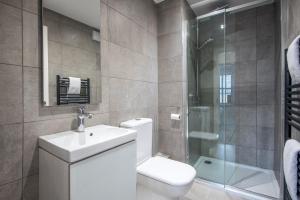 a bathroom with a toilet and a sink and a shower at Fifty Two Old Elvet in Durham +55 photos