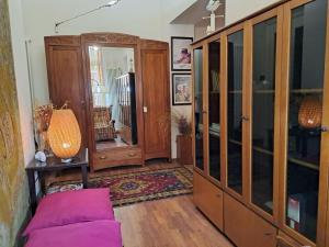 a living room with a large wooden cabinet at Appartamento Le Corti 2 in Alessandria