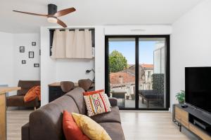 a living room with a couch and a flat screen tv at Comfy Counord place in Bordeaux