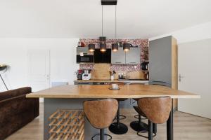 a kitchen with a large wooden table and chairs at Comfy Counord place in Bordeaux +14 photos