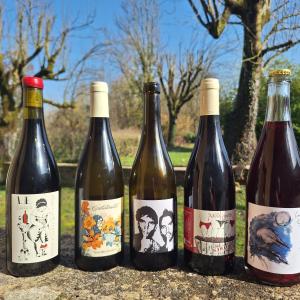 four bottles of wine sitting on a table at La Pépite in Margut +34 photos