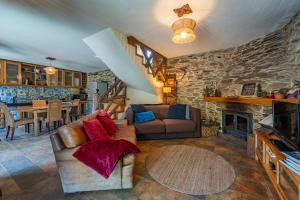 a living room with a couch and a fireplace at Casa da Figueira - Rio Paiva in Arouca +35 photos