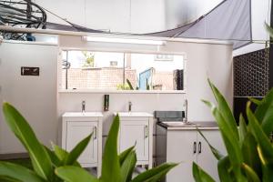 a bathroom with two sinks in a building with plants at Saigon Box Hostel in Ho Chi Minh City