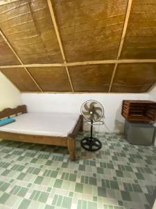 a bedroom with a bed and a wooden ceiling at Simai house in Nungwi +6 photos