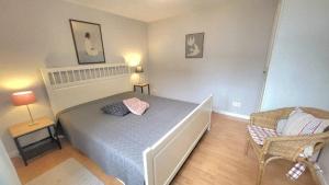 a small bedroom with a bed and a chair at Ferienhaus Friedrich-Borge-Straße in Kühlungsborn