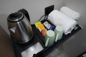 a table with a coffee pot and towels on it at TheCloud Hotel in Nizāmābād