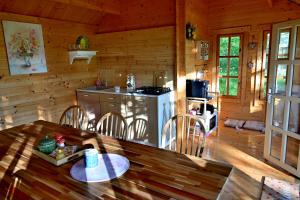 a kitchen with a table and a stove in a cabin at La Salcami in Mohu +79 photos