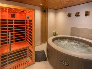 a large bathroom with a large tub in a room at Apartman DIVAN in Ladimirevci