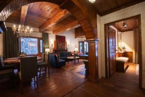 a living room with a table and a dining room at Secret Garden Kalam in Kalām
