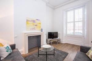 a living room with a couch and a fireplace at Fifty Two Old Elvet in Durham