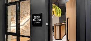 a sign on the door of a building at Corto Maltese Boutique in Athens