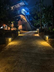 an empty street at night with lights at Mountain pride homestay in Meppādi +1 photo