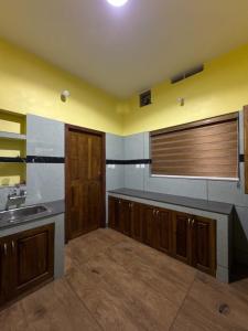 a large kitchen with a sink and a counter at Mountain pride homestay in Meppādi