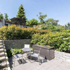 a patio with a table and chairs and an umbrella at Apartmenthouse Viktoria in Bern in Bern
