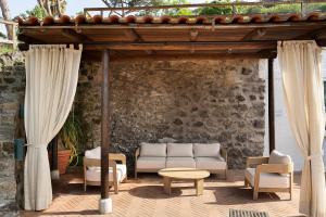 a patio with a couch and a table and chairs at Hotel Oasi Castiglione in Casamicciola Terme +71 photos