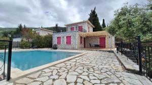 a villa with a swimming pool in front of a house at Harmony and Horizon villas in Athani