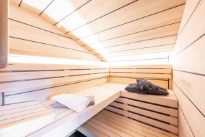a wooden sauna with a blanket and a pillow at Waldchalets & Ferienwohnungen Allgäu in Burgberg +11 photos