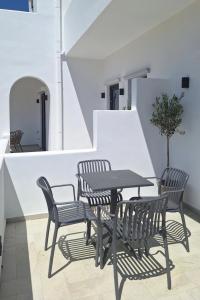 a table and chairs sitting on a patio at Smovolo houses 1 in Agios Sostis