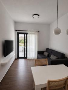 a living room with a couch and a table at Smovolo houses 1 in Agios Sostis