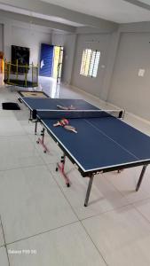 a ping pong table in a room with a ping pong ball at Raghav Sarkar Parisar in Indore