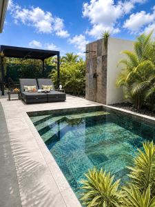 a swimming pool in the backyard of a house at Villa Docéa in Sainte-Anne