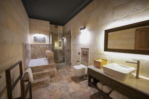 a bathroom with two sinks and a shower and a toilet at Sinasos Evleri in Nevşehir +145 photos